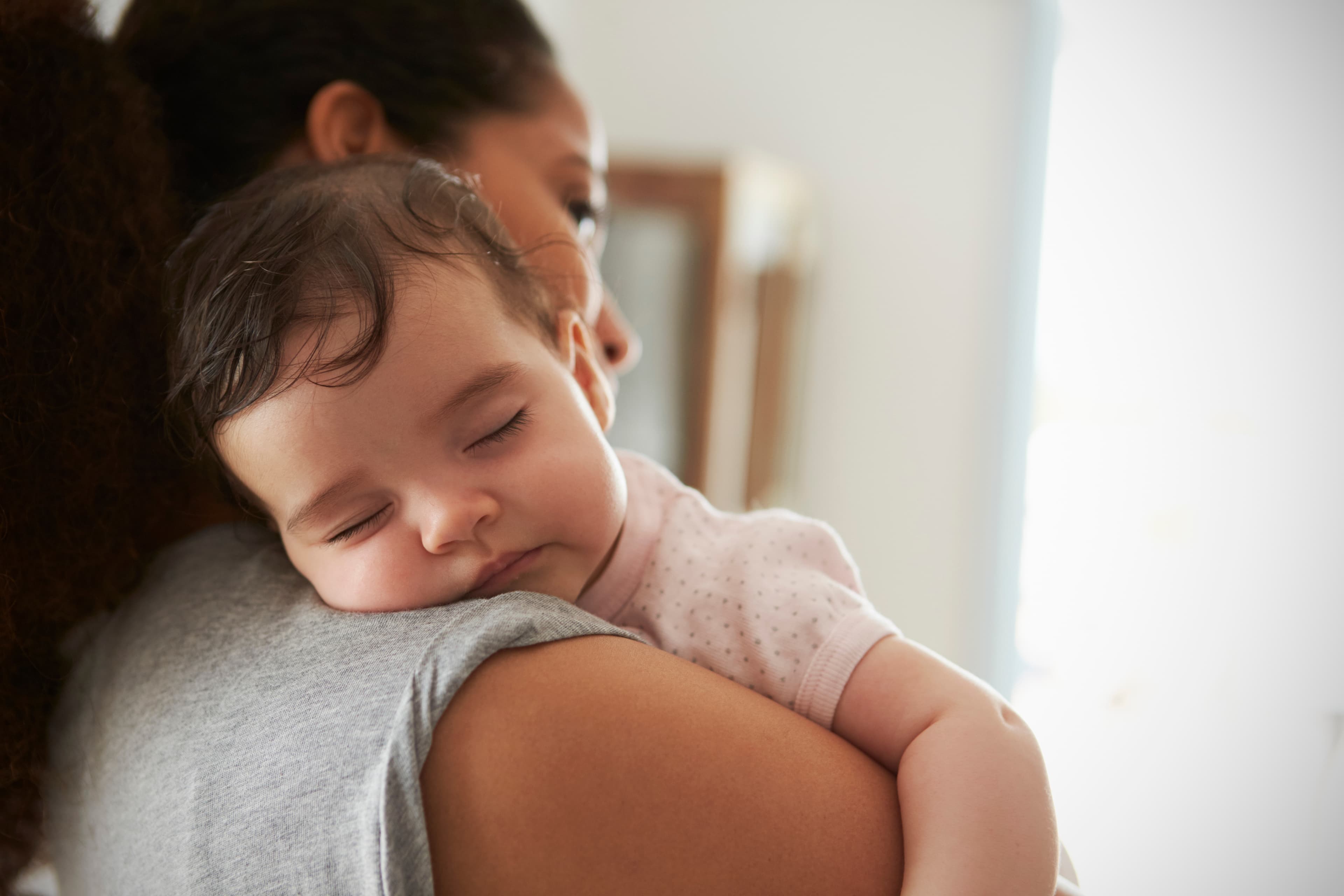 Mother holding a sleeping baby