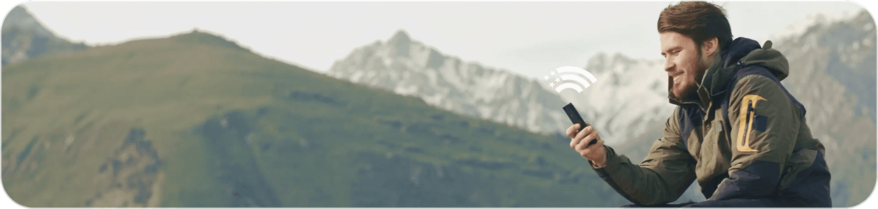 Man using a phone in the mountains
